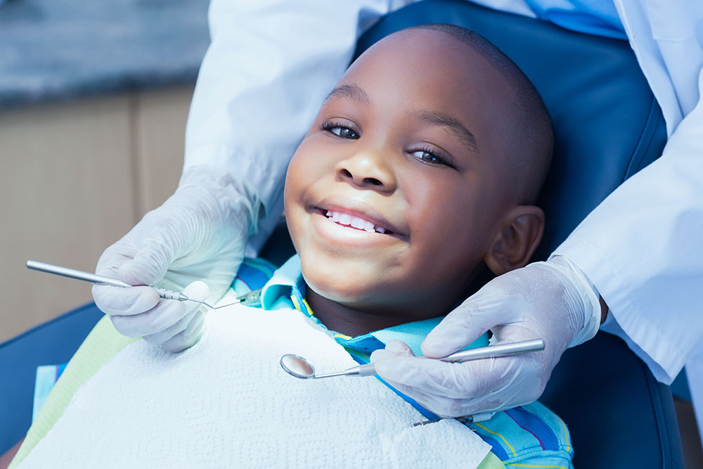 Why is it important that children go to the dentist? When should they first go?